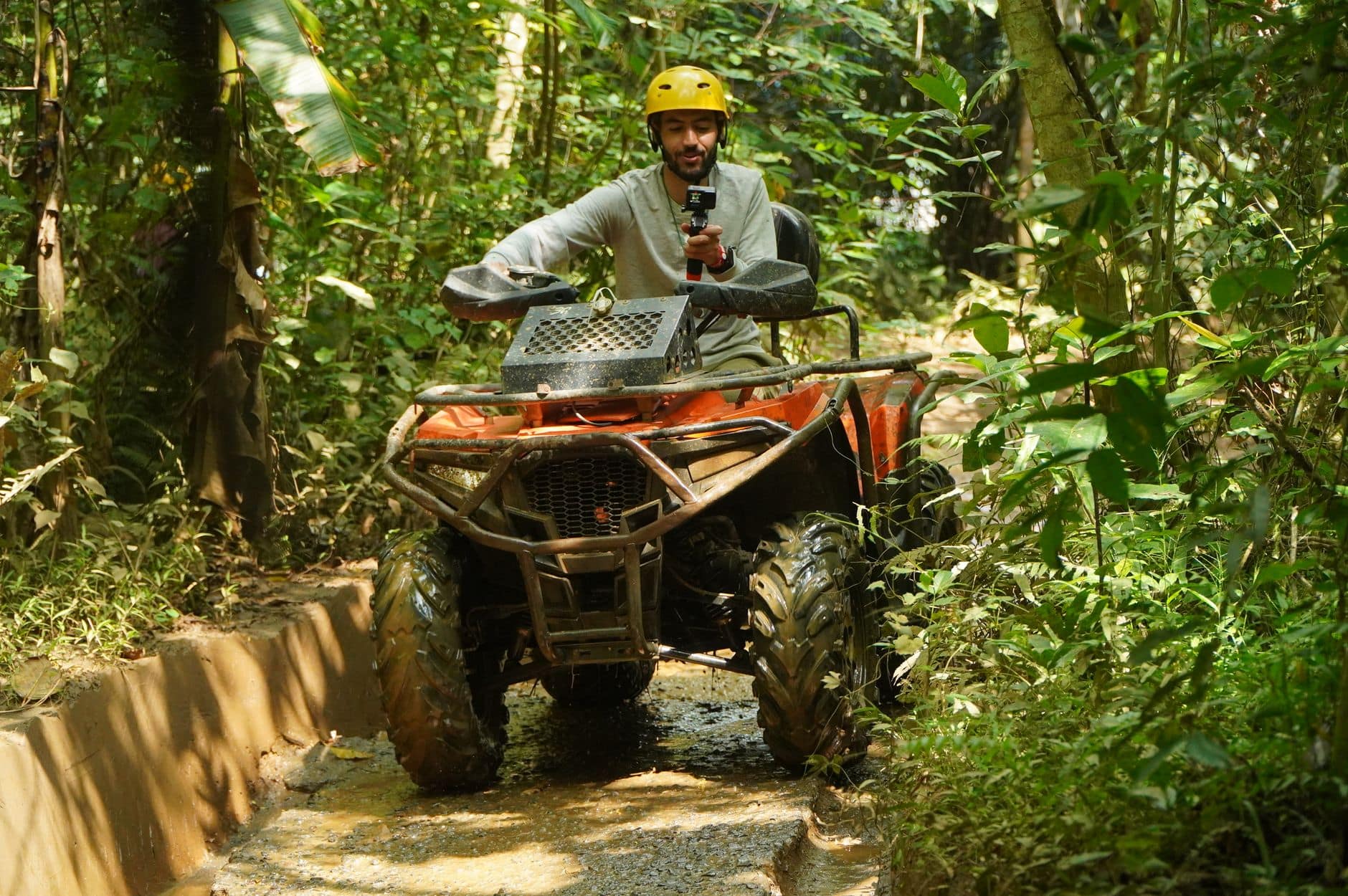 ATV quad bike on a muddy jungle trail during a Bali off-road adventure